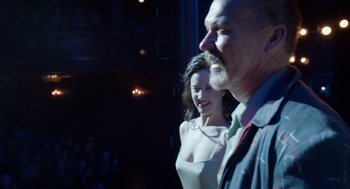 Movie still from “Birdman or (The Unexpected Virtue of Ignorance)” (2014), directed by Alejandro G. Iñárritu – A man and a woman standing next to each other; Medium shot, Over the shoulder angle