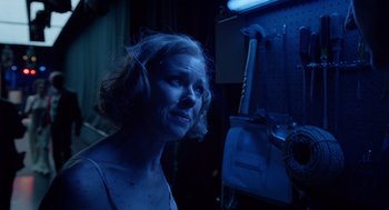Movie still from “Birdman or (The Unexpected Virtue of Ignorance)” (2014), directed by Alejandro G. Iñárritu – A woman in a dark room looking at the camera; Close Up shot, Low angle