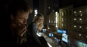 Movie still from “Birdman or (The Unexpected Virtue of Ignorance)” (2014), directed by Alejandro G. Iñárritu – A man and a woman sitting on a balcony at night; Medium shot, Low angle