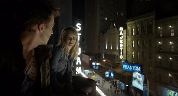Movie still from “Birdman or (The Unexpected Virtue of Ignorance)” (2014), directed by Alejandro G. Iñárritu – A man and a woman sitting on a ledge in front of a building at night; Medium shot, Over the shoulder angle
