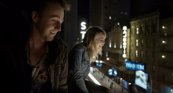 Movie still from “Birdman or (The Unexpected Virtue of Ignorance)” (2014), directed by Alejandro G. Iñárritu – A man and a woman looking out of a window at night; Medium shot, Over the shoulder angle