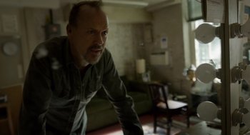 Movie still from “Birdman or (The Unexpected Virtue of Ignorance)” (2014), directed by Alejandro G. Iñárritu – A man standing in a living room looking at the camera; Medium shot, Over the shoulder angle
