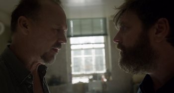 Movie still from “Birdman or (The Unexpected Virtue of Ignorance)” (2014), directed by Alejandro G. Iñárritu – Two men face to face in a room with a window in the background; Close Up shot, Over the shoulder angle