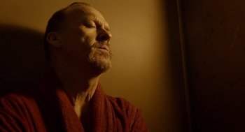Movie still from “Birdman or (The Unexpected Virtue of Ignorance)” (2014), directed by Alejandro G. Iñárritu – A person wearing a robe; Close Up shot, Low angle