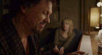 Movie still from “Birdman or (The Unexpected Virtue of Ignorance)” (2014), directed by Alejandro G. Iñárritu – A man and a woman sitting on a couch looking at a tablet computer; Close Up shot, Over the shoulder angle