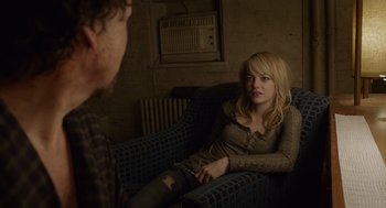 Movie still from “Birdman or (The Unexpected Virtue of Ignorance)” (2014), directed by Alejandro G. Iñárritu – A woman sitting on top of a blue couch next to a man; Medium shot, Over the shoulder angle