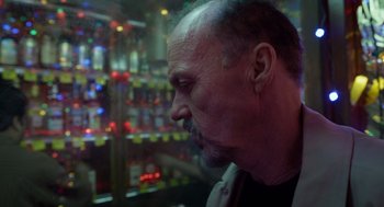 Movie still from “Birdman or (The Unexpected Virtue of Ignorance)” (2014), directed by Alejandro G. Iñárritu – A man with a beard is looking out of a window; Close Up shot, Low angle