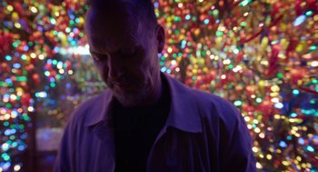 Movie still from “Birdman or (The Unexpected Virtue of Ignorance)” (2014), directed by Alejandro G. Iñárritu – A man standing in front of a wall of lights; Close Up shot, Low angle