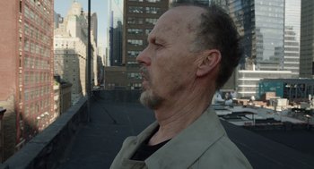 Movie still from “Birdman or (The Unexpected Virtue of Ignorance)” (2014), directed by Alejandro G. Iñárritu – A person wearing a jacket on a city street; Close Up shot, Low angle