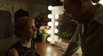 Movie still from “Birdman or (The Unexpected Virtue of Ignorance)” (2014), directed by Alejandro G. Iñárritu – A man and a woman talking in front of a lighted mirror; Medium shot, Over the shoulder angle