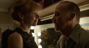 Movie still from “Birdman or (The Unexpected Virtue of Ignorance)” (2014), directed by Alejandro G. Iñárritu – A man and a woman face to face in front of lights; Close Up shot, Low angle