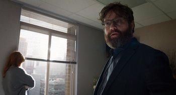 Movie still from “Birdman or (The Unexpected Virtue of Ignorance)” (2014), directed by Alejandro G. Iñárritu – A man in a suit and tie standing in front of a window; Close Up shot, Low angle