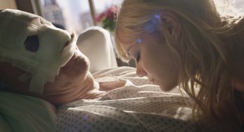 Movie still from “Birdman or (The Unexpected Virtue of Ignorance)” (2014), directed by Alejandro G. Iñárritu – A young girl laying in a hospital bed looking at an old man; Extreme Close Up shot, Over the shoulder angle