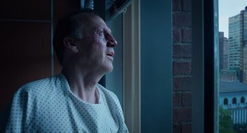 Movie still from “Birdman or (The Unexpected Virtue of Ignorance)” (2014), directed by Alejandro G. Iñárritu – An older man in a hospital gown looking out a window; Close Up shot, Low angle