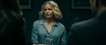Movie still from “The Boys” (2019), created by Eric Kripke – A woman in a blue shirt is looking at the camera; Medium shot, Over the shoulder angle