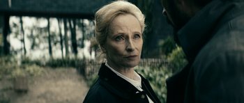 Movie still from “The Boys” (2019), created by Eric Kripke – An older woman with blonde hair looking at the camera; Close Up shot, Over the shoulder angle