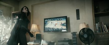 Movie still from “The Boys” (2019), created by Eric Kripke – A tv mounted to the wall in a living room; Medium shot, High angle