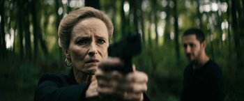 Movie still from “The Boys” (2019), created by Eric Kripke – A woman is holding a gun in the woods; Close Up shot, Over the shoulder angle
