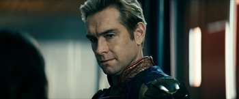 Movie still from “The Boys” (2019), created by Eric Kripke – A person wearing a suit; Close Up shot, Over the shoulder angle