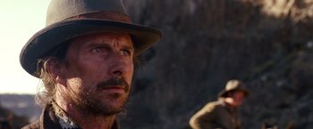 Movie still from “3:10 to Yuma” (2007), directed by James Mangold – A person wearing a hat; Close Up shot, Over the shoulder angle