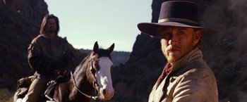 Movie still from “3:10 to Yuma” (2007), directed by James Mangold – A man with a cowboy hat on and a horse; Close Up shot, Low angle