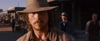 Movie still from “3:10 to Yuma” (2007), directed by James Mangold – A man with a beard and a hat and a man with a beard and a hat; Close Up shot, Over the shoulder angle