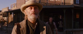 Movie still from “3:10 to Yuma” (2007), directed by James Mangold – A man with a long beard wearing a cowboy hat; Close Up shot, Low angle