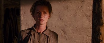 Movie still from “3:10 to Yuma” (2007), directed by James Mangold – A woman standing in front of a brick wall; Close Up shot, Over the shoulder angle