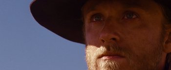 Movie still from “3:10 to Yuma” (2007), directed by James Mangold – A man with a beard wearing a cowboy hat; Close Up shot, Low angle
