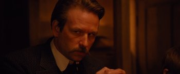 Movie still from “3:10 to Yuma” (2007), directed by James Mangold – A person wearing a suit and tie; Close Up shot, Low angle