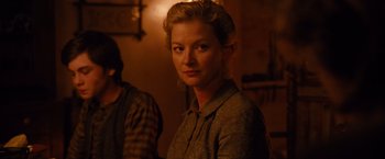 Movie still from “3:10 to Yuma” (2007), directed by James Mangold – A woman standing next to a man in a room; Close Up shot, Over the shoulder angle