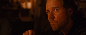 Movie still from “3:10 to Yuma” (2007), directed by James Mangold – A person with a beard looking at the camera; Close Up shot, Over the shoulder angle