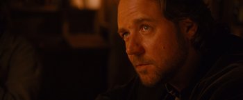 Movie still from “3:10 to Yuma” (2007), directed by James Mangold – A person wearing headphones and looking into the distance; Close Up shot, Over the shoulder angle
