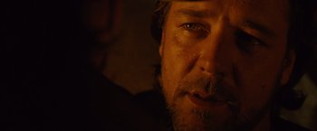 Movie still from “3:10 to Yuma” (2007), directed by James Mangold – A person with a beard looking at the camera; Close Up shot, Over the shoulder angle