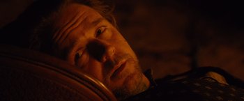 Movie still from “3:10 to Yuma” (2007), directed by James Mangold – A man's face in the dark; Close Up shot, Overhead angle