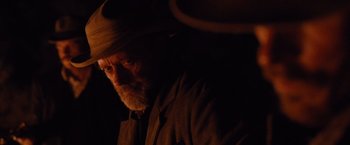 Movie still from “3:10 to Yuma” (2007), directed by James Mangold – An old man with a beard wearing a cowboy hat; Close Up shot, Over the shoulder angle