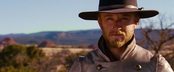 Movie still from “3:10 to Yuma” (2007), directed by James Mangold – A man with a beard wearing a hat and a jacket; Close Up shot, Low angle