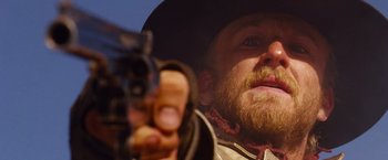 Movie still from “3:10 to Yuma” (2007), directed by James Mangold – A person holding a gun; Close Up shot, Low angle