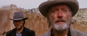 Movie still from “3:10 to Yuma” (2007), directed by James Mangold – An old man with a gray beard wearing a cowboy hat; Close Up shot, Low angle