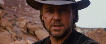 Movie still from “3:10 to Yuma” (2007), directed by James Mangold – A person wearing a hat and looking at the camera; Close Up shot, Over the shoulder angle