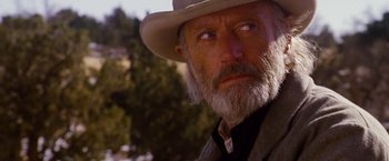 Movie still from “3:10 to Yuma” (2007), directed by James Mangold – An old man with a gray beard wearing a hat; Close Up shot, Low angle