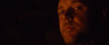 Movie still from “3:10 to Yuma” (2007), directed by James Mangold – A man's face with a dark background; Close Up shot, Over the shoulder angle