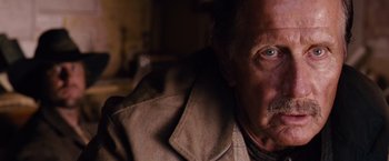 Movie still from “3:10 to Yuma” (2007), directed by James Mangold – A person wearing a jacket; Close Up shot, Low angle