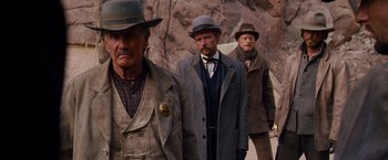 Movie still from “3:10 to Yuma” (2007), directed by James Mangold – A group of men standing next to each other on top of a hill; Medium shot, Low angle