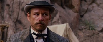 Movie still from “3:10 to Yuma” (2007), directed by James Mangold – A person wearing a hat and a tie; Close Up shot, Low angle