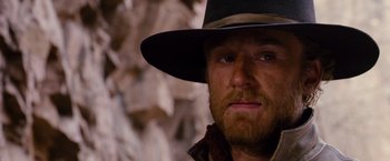 Movie still from “3:10 to Yuma” (2007), directed by James Mangold – A person wearing a hat; Close Up shot, Over the shoulder angle