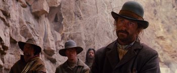 Movie still from “3:10 to Yuma” (2007), directed by James Mangold – A group of men standing next to each other on top of a hill; Close Up shot, Over the shoulder angle