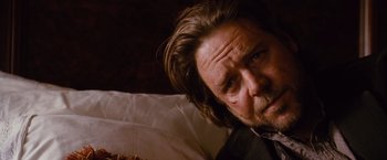 Movie still from “3:10 to Yuma” (2007), directed by James Mangold – A person laying on a bed; Close Up shot, Over the shoulder angle