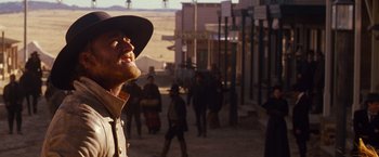 Movie still from “3:10 to Yuma” (2007), directed by James Mangold – A man with a beard wearing a cowboy hat; Medium shot, Low angle
