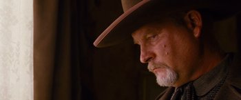 Movie still from “3:10 to Yuma” (2007), directed by James Mangold – An older man wearing a cowboy hat looking to his left; Close Up shot, Low angle